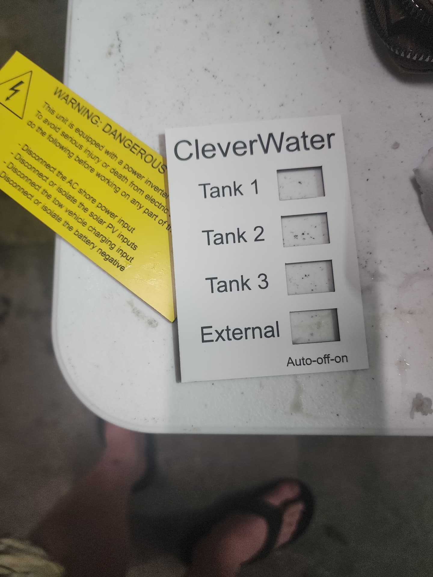 CleverWater tank selector panel and dangerous voltage warning label
