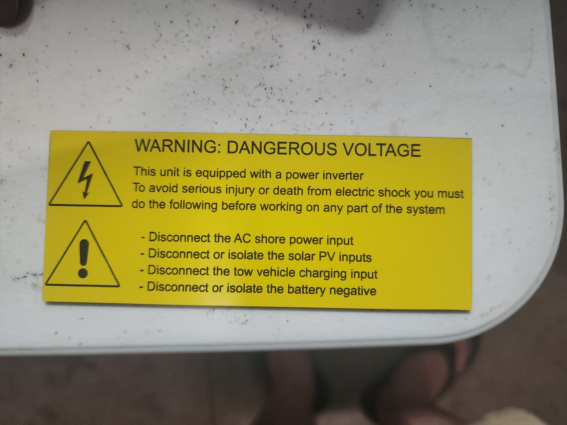 Yellow traffolyte dangerous voltage warning label with warning symbols