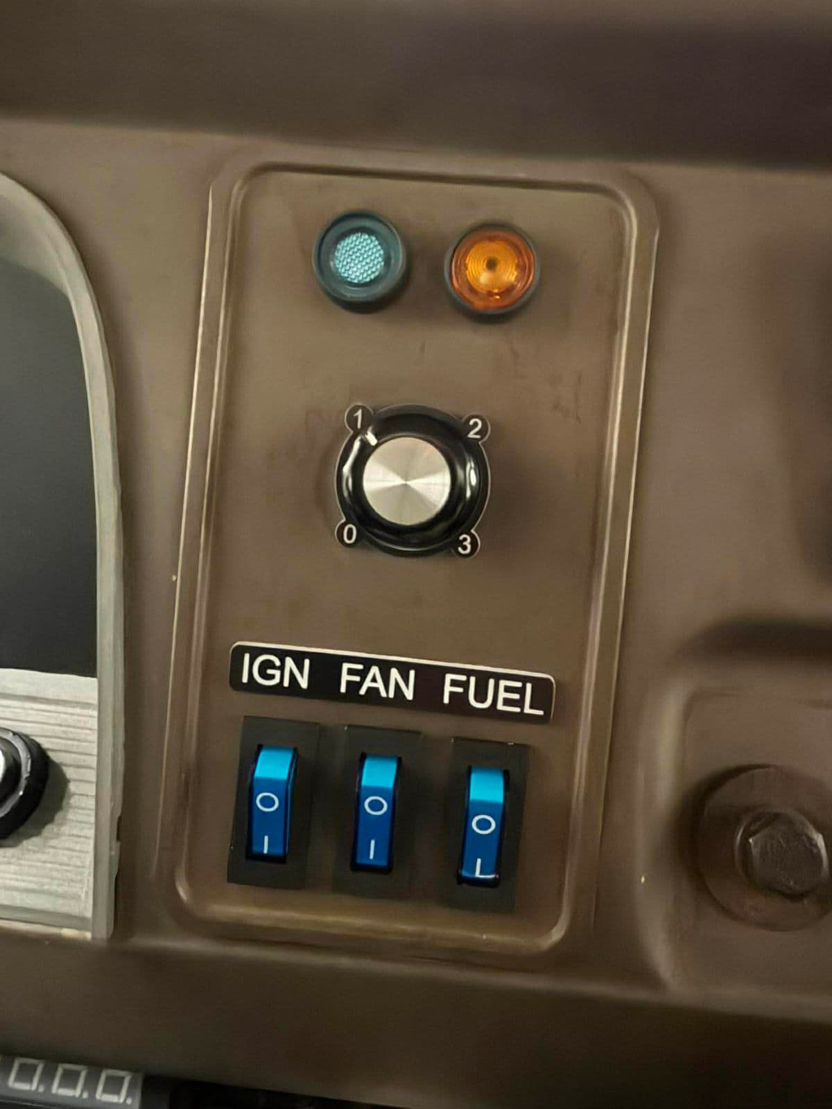 Black traffolyte IGN FAN FUEL switch label installed on a vehicle dash panel above three rocker switches
