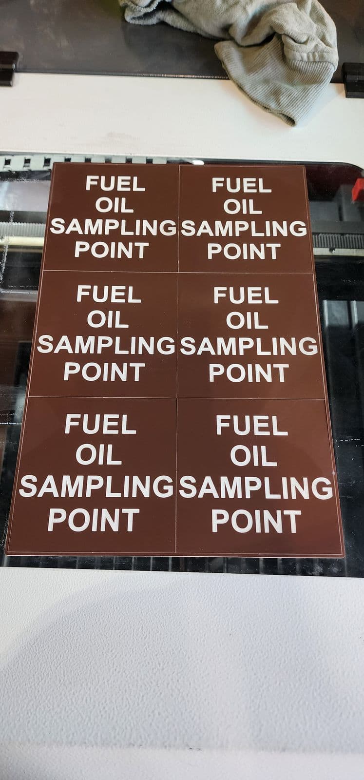 Sheet of six brown and white traffolyte Fuel Oil Sampling Point signs freshly laser-cut