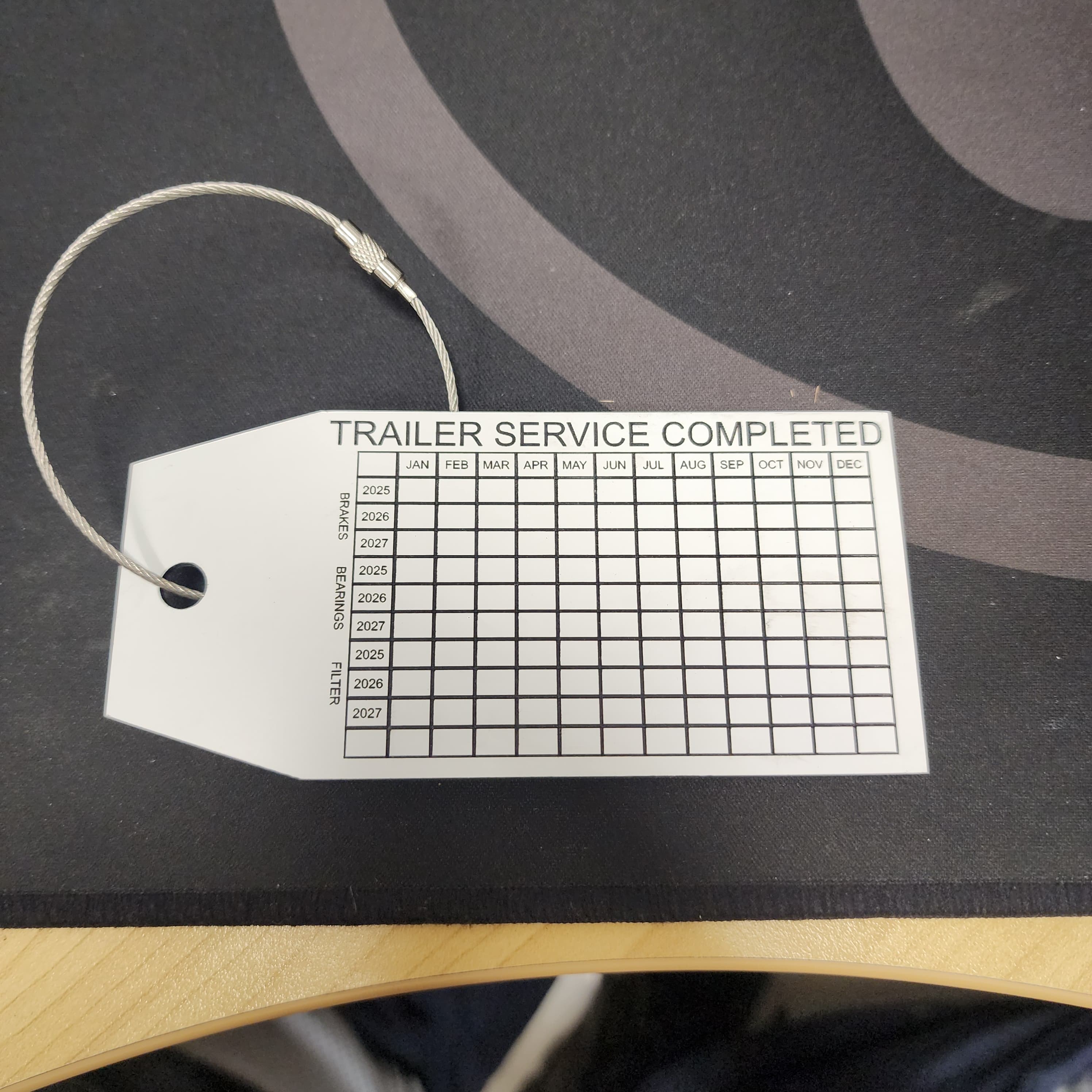 Trailer service completed tag with wire loop - maintenance tracking