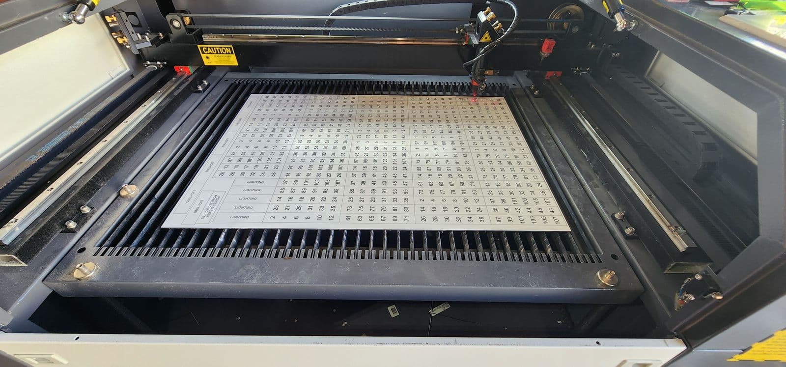 A full sheet of scheduled labels being engraved on the RBZ 3D laser