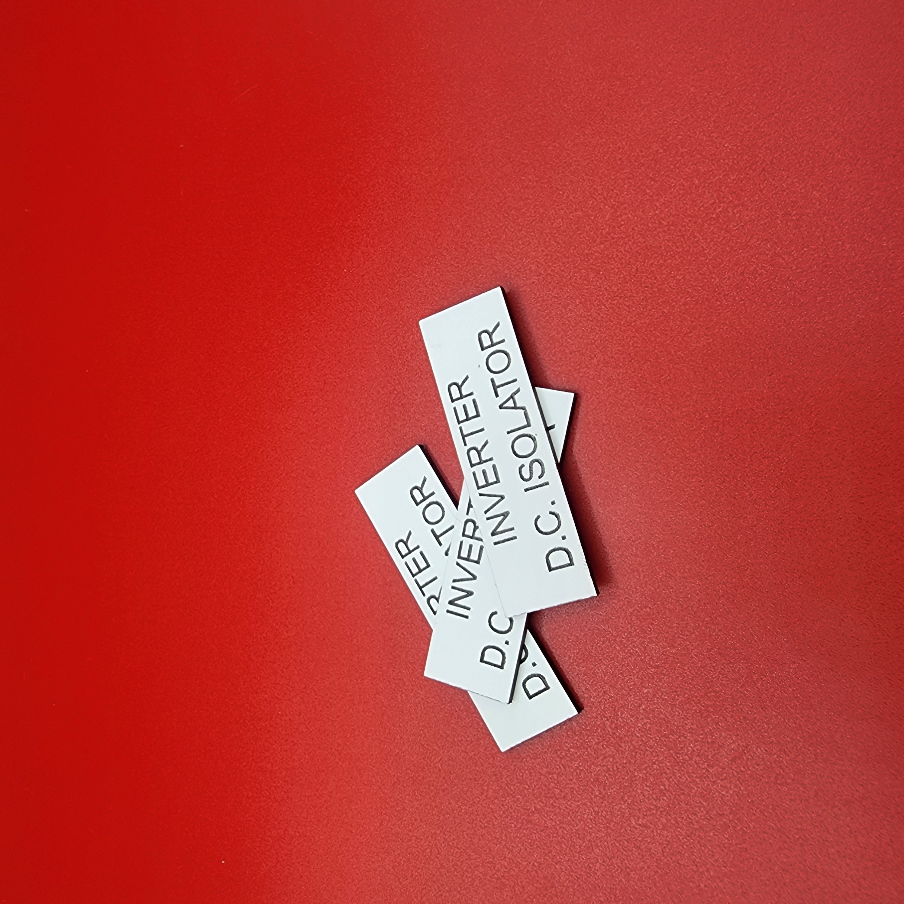 Engraved DC and inverter isolator labels, the kind checked at every isolation point during a site audit